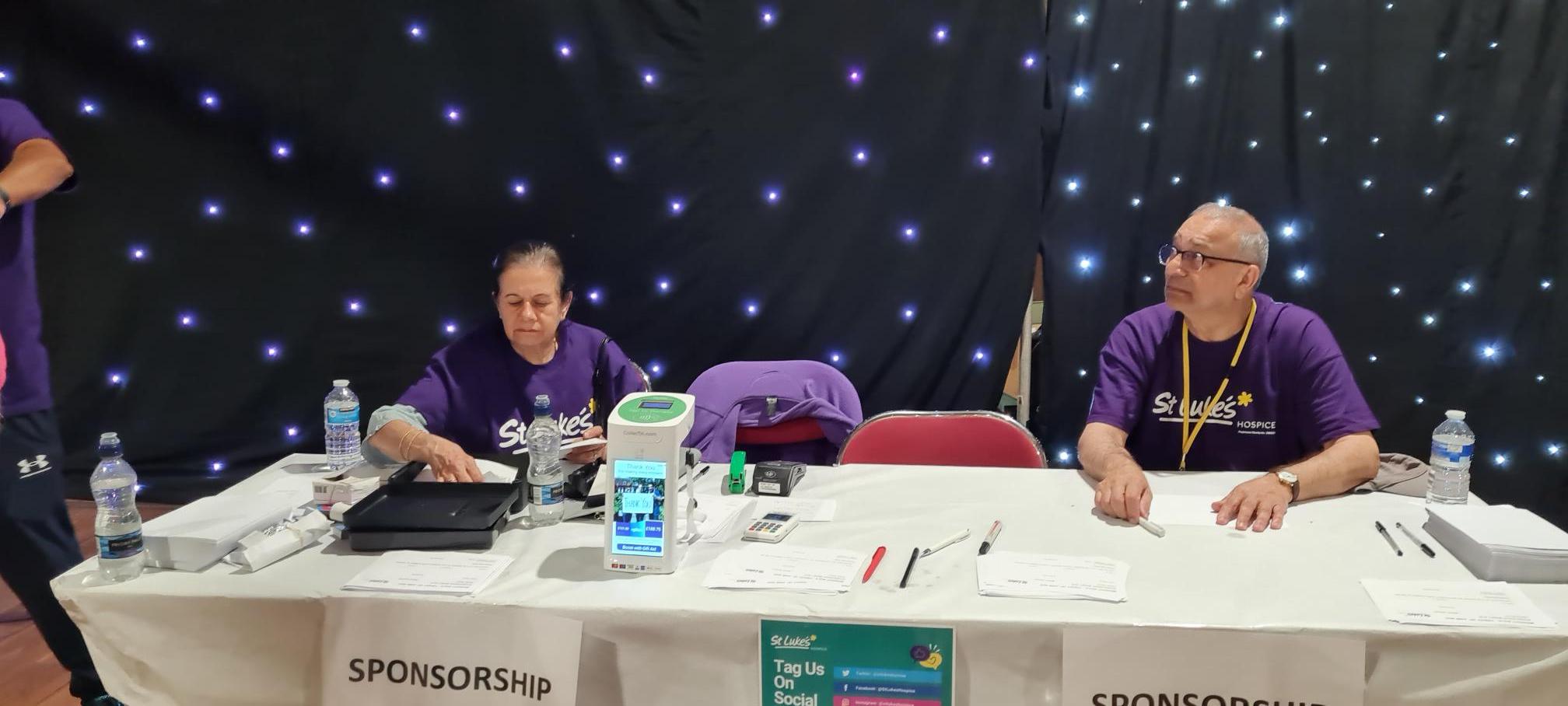 St Luke's Hospice volunteers at an event ready to use the CollecTin for donations.